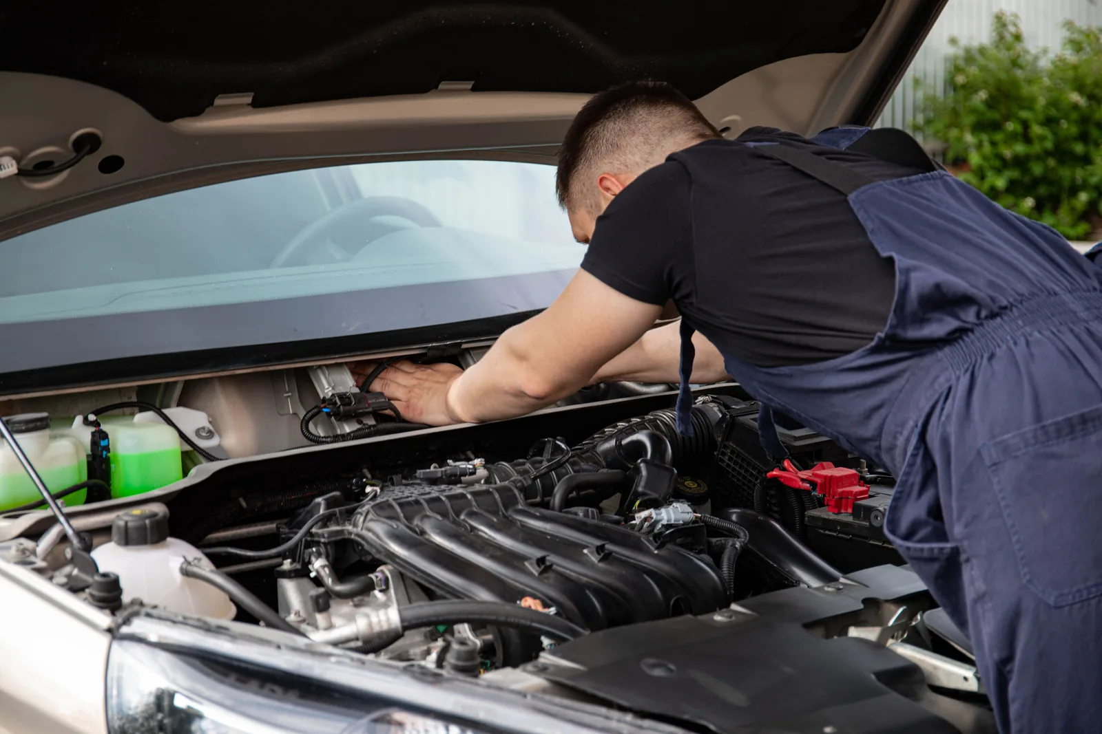 Stock photo of a mechanic working under the hood of a vehicle