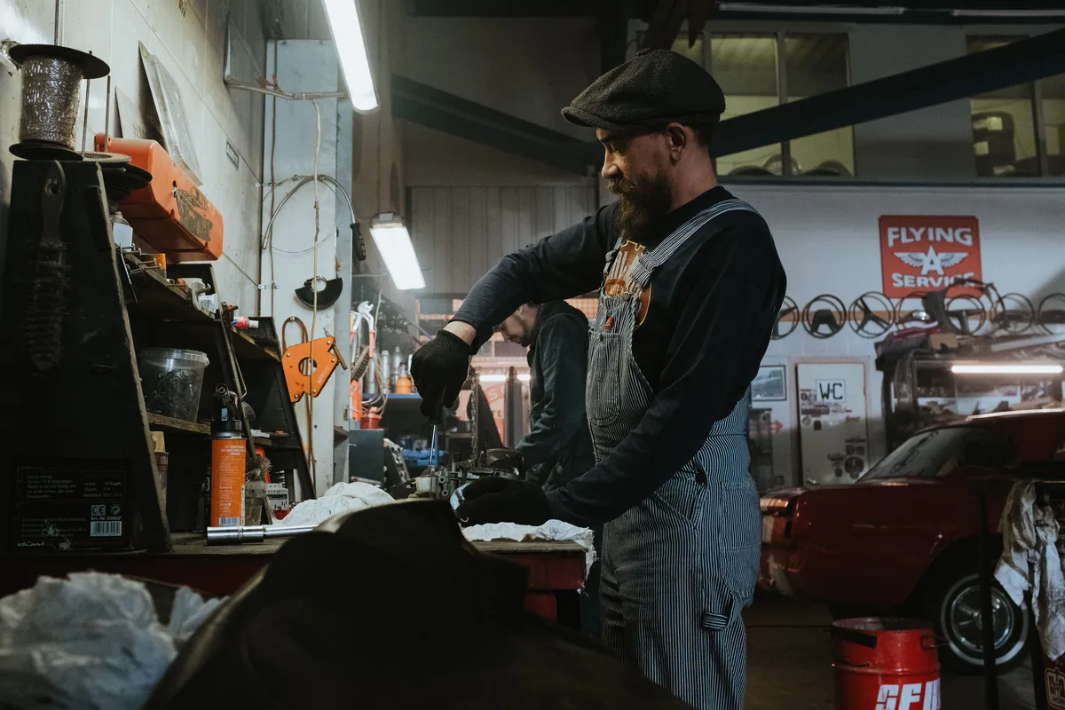 Stock photo of a mechanic working at an automotive workbench